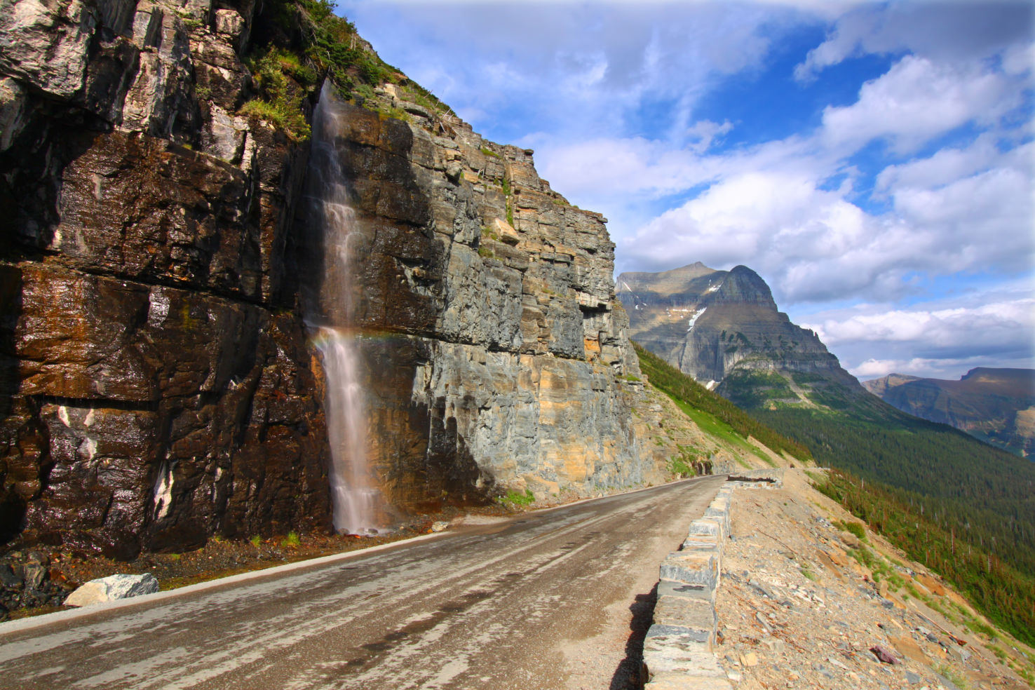 Waterfall flowing onto the Going To The Sun Road - Montana