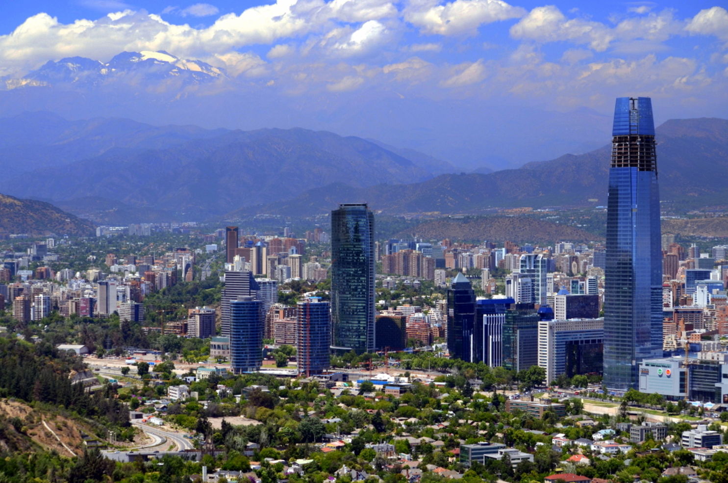 The view of modern Santiago, Chile with the Andes mountains on the horizon.