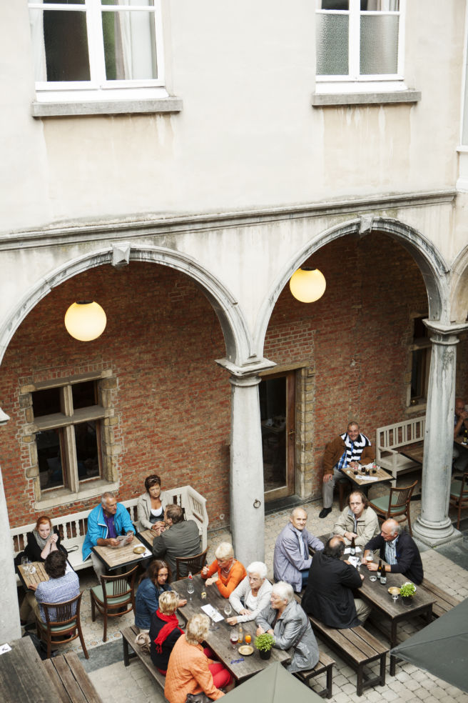 People enjoying the evening at a bar called "de groote witte arend" in Antwerp, Belgium