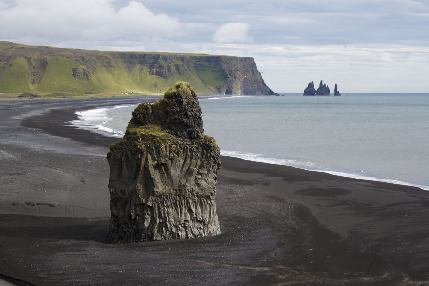 Sea stack with Reynisdrangar (troll pillars) in the distance, southern coast.