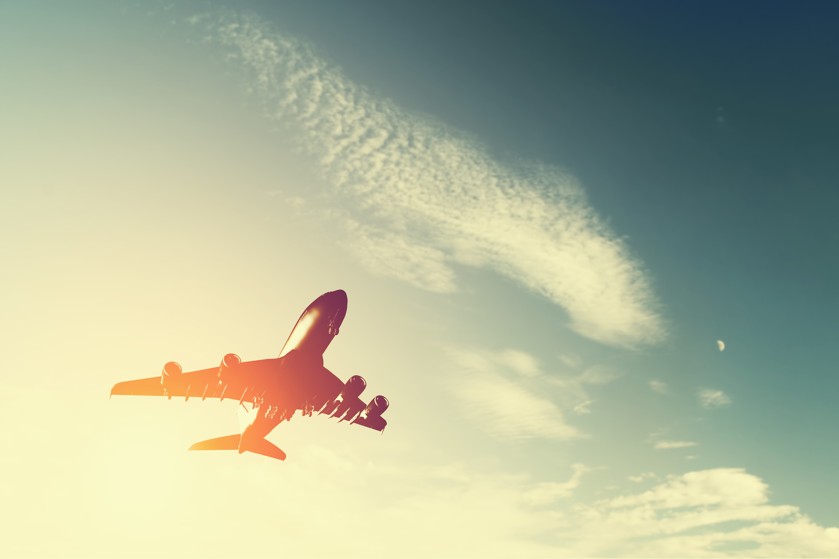 looking up at airplane taking off