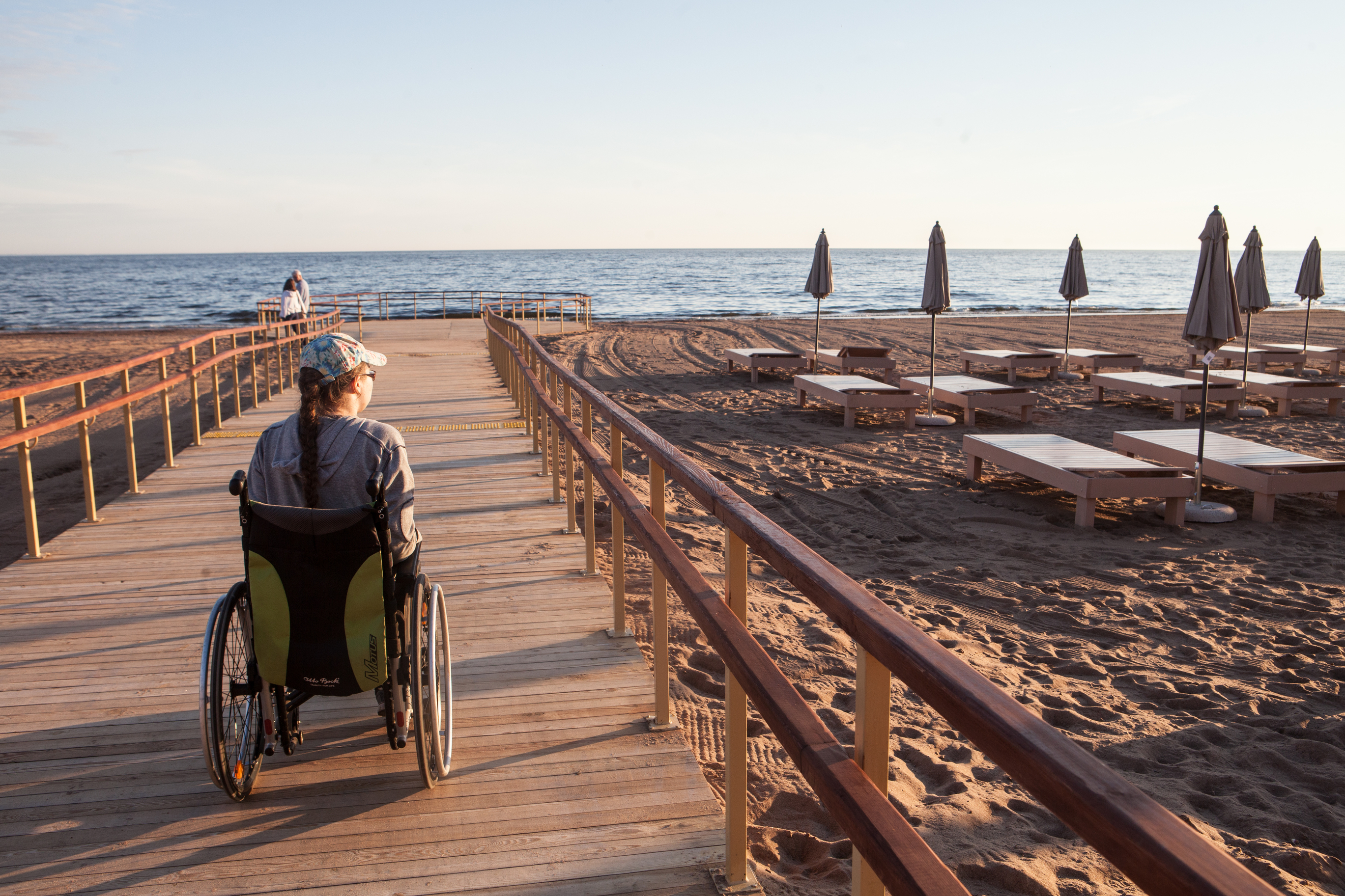 Woman in wheel chair on boardwalk